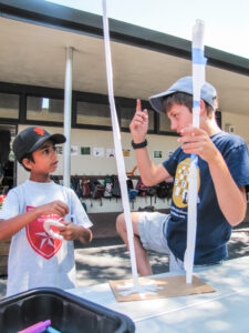 Boys Discussing Paper Towers (Portrait)