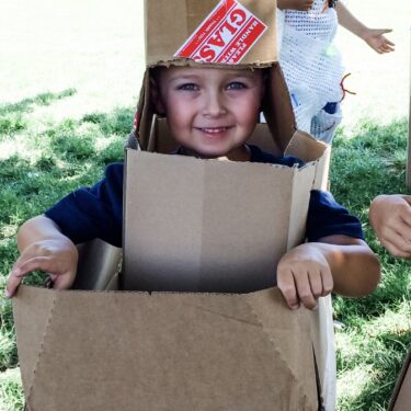 Boy in Cardboard Tower (Large Square)