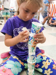 Girl Building Cup Tower (Portrait)